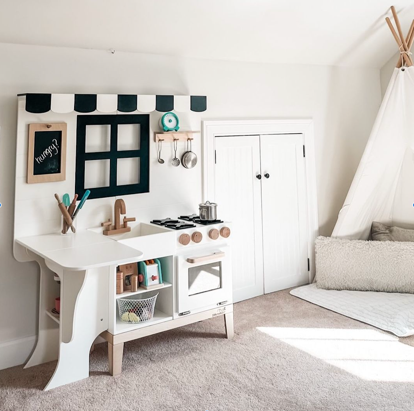 Play kitchen in a clean, white room