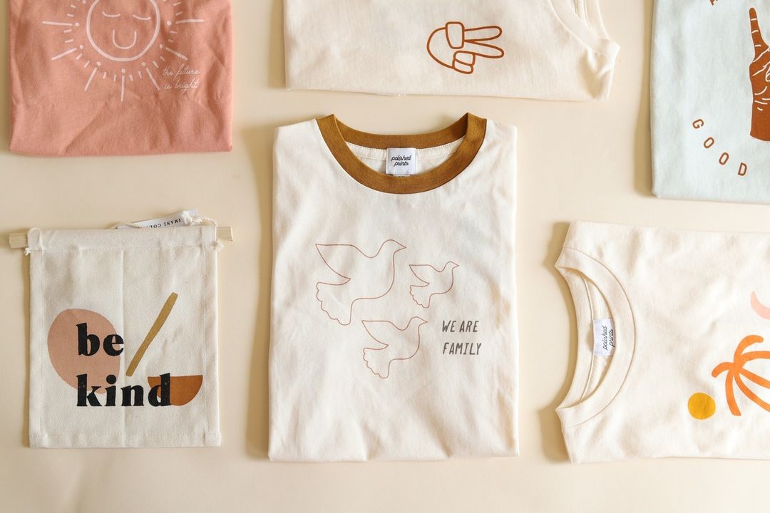 Graphic printed tees and home goods laying flat on a table